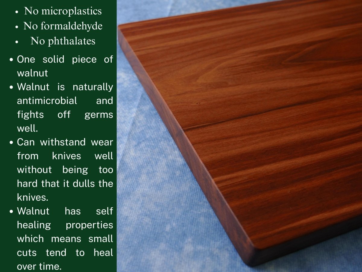 black walnut cutting board on a blue background