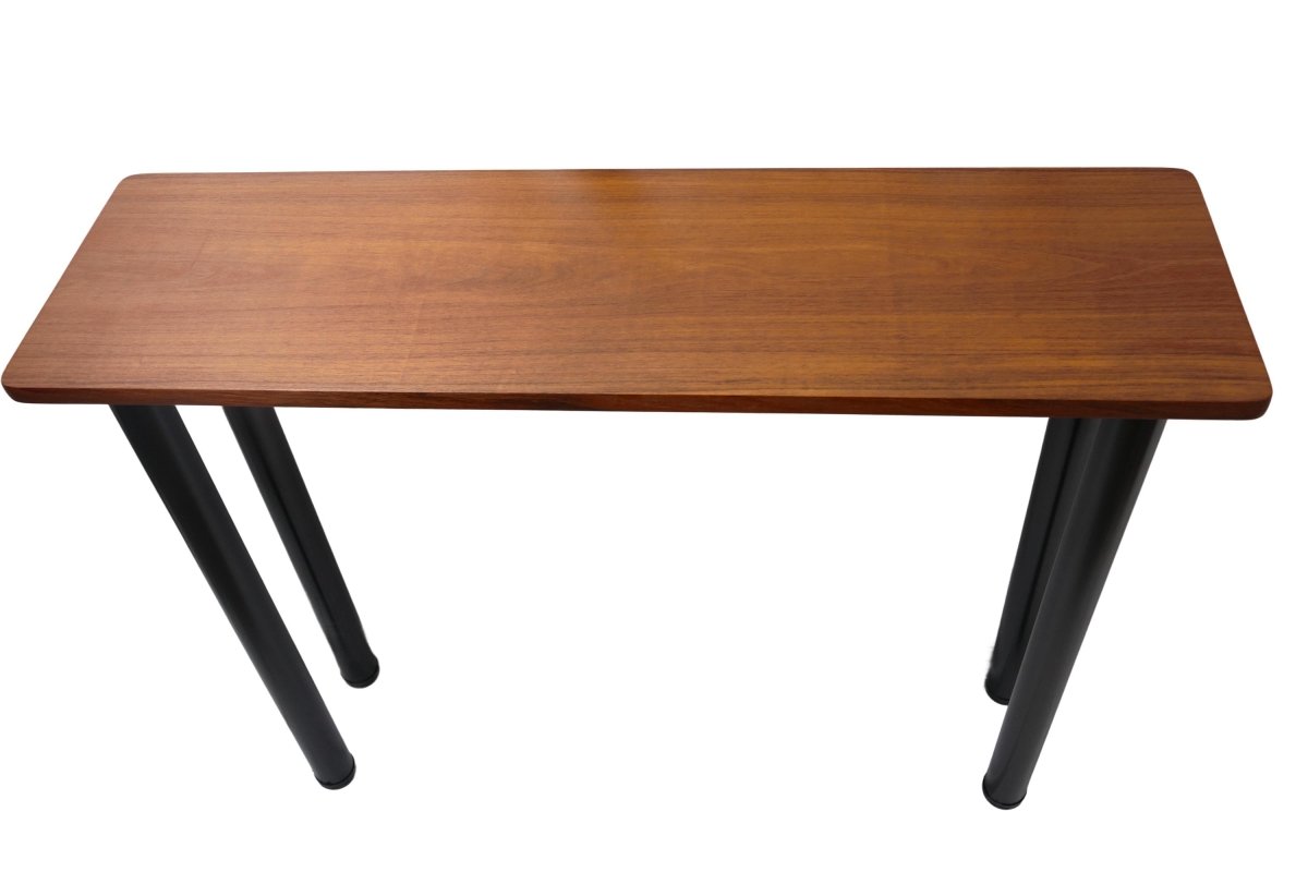 a wooden table sitting on top of a white sheet