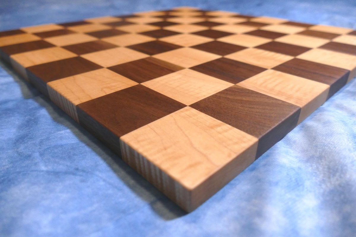 a close up of a chess board on a bed