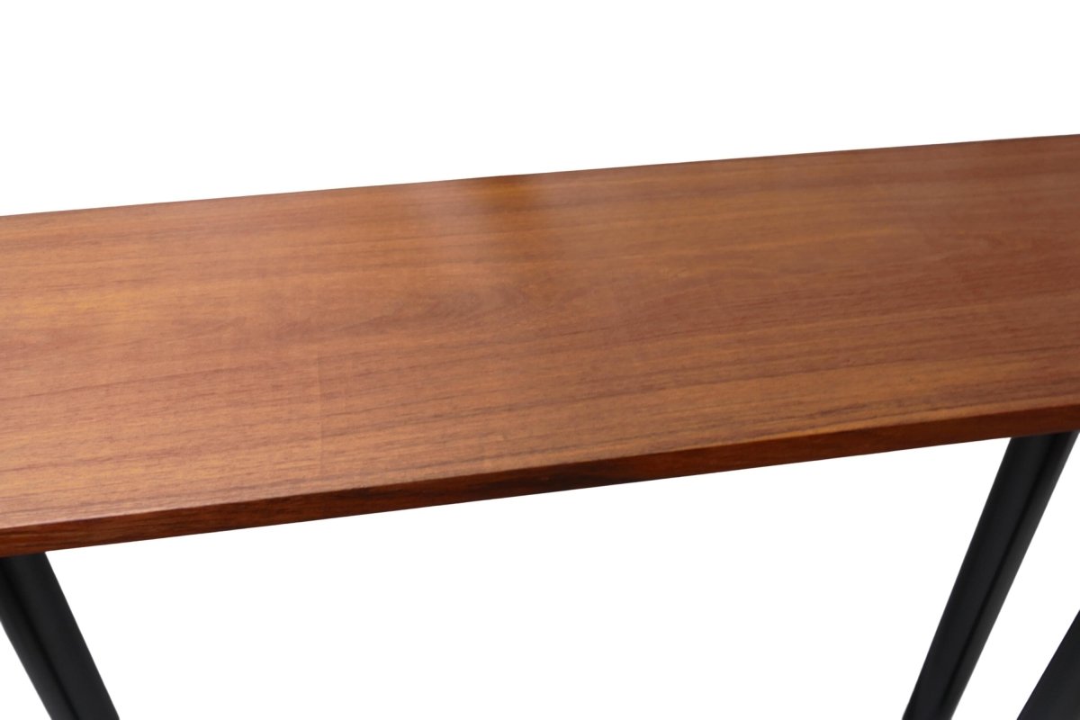 a wooden table with metal legs on a white background