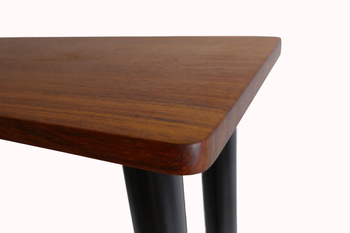 a close up of a wooden table with metal legs