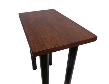 a black walnut table with round black metal legs on a white background