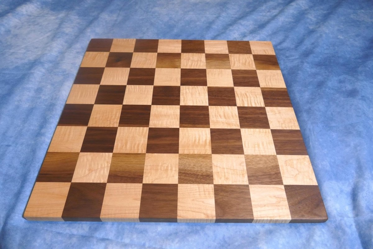 a wooden chess board on a blue blanket