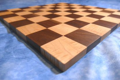 a close up of a chess board on a bed