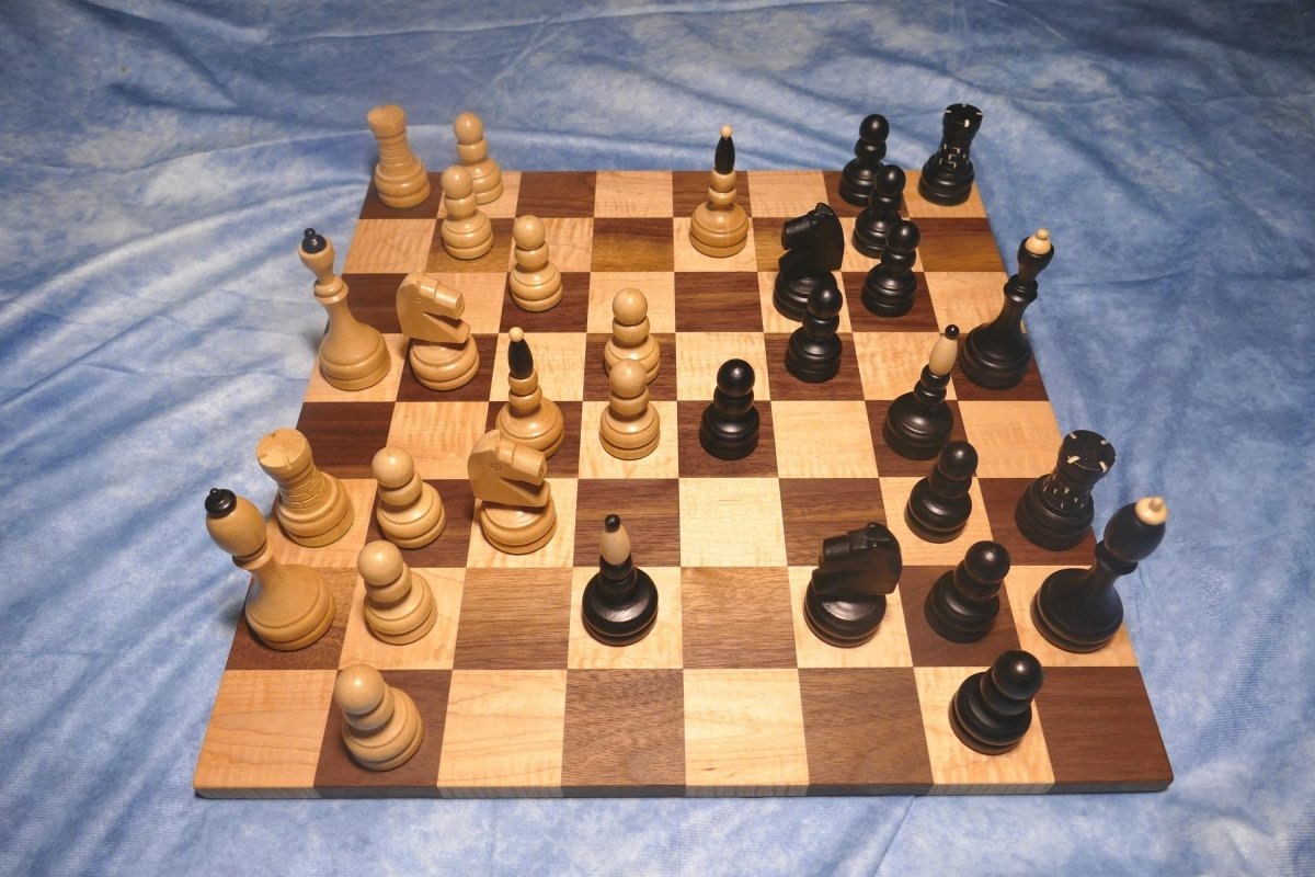 a wooden chess board with chess pieces on it