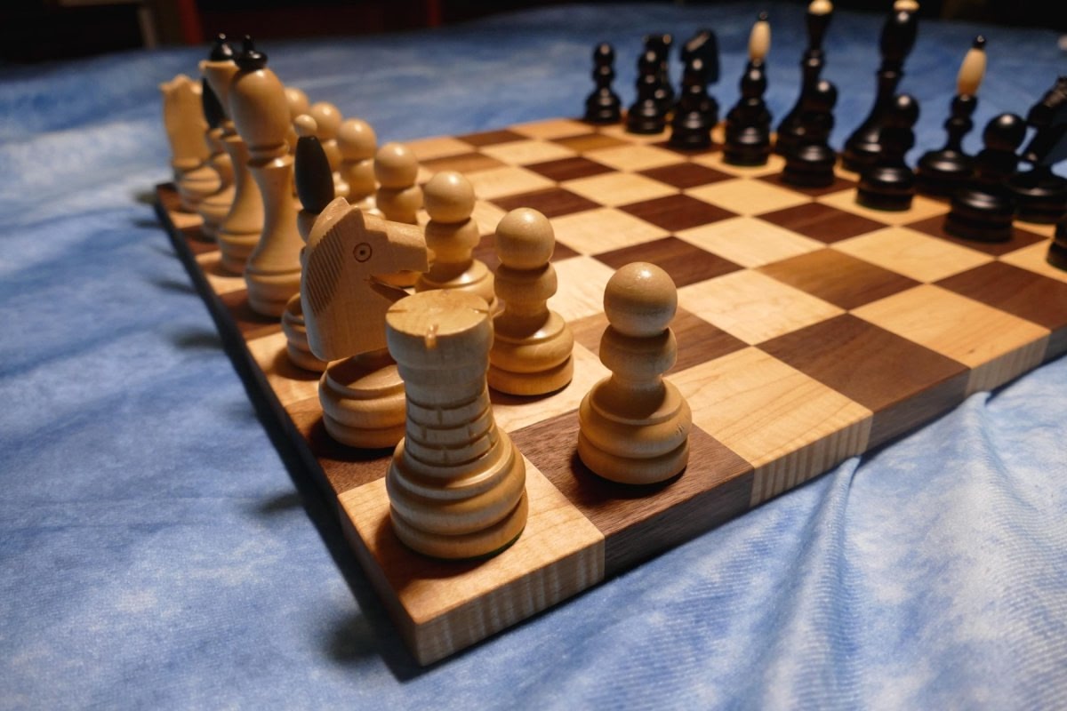 a wooden chess board with chess pieces on it