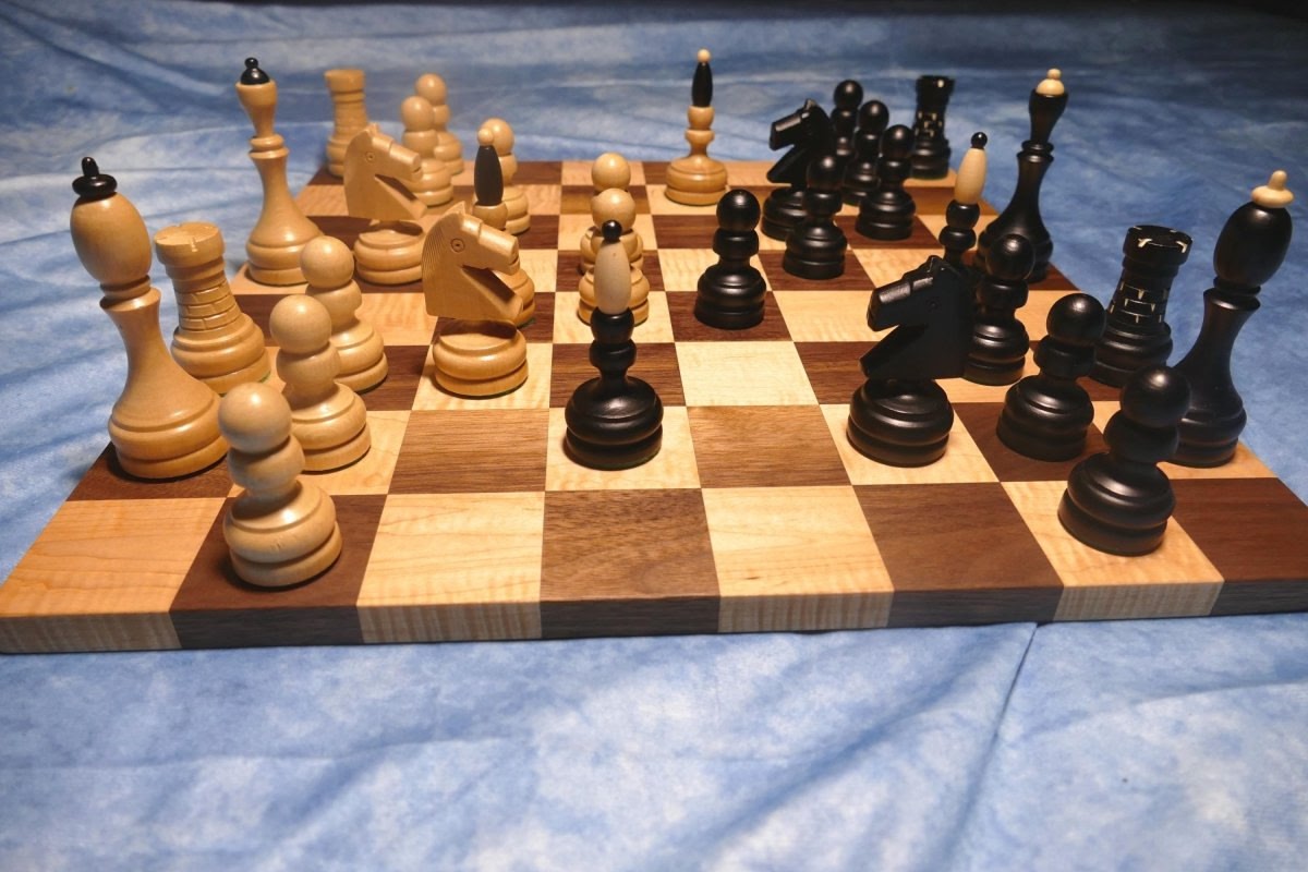 a wooden chess board with chess pieces on it