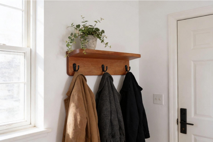 Mahogany coat rack with shelf next entryway on wall