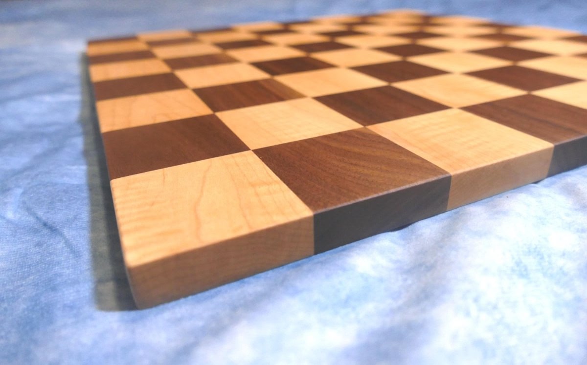 a close up of a chess board on a bed